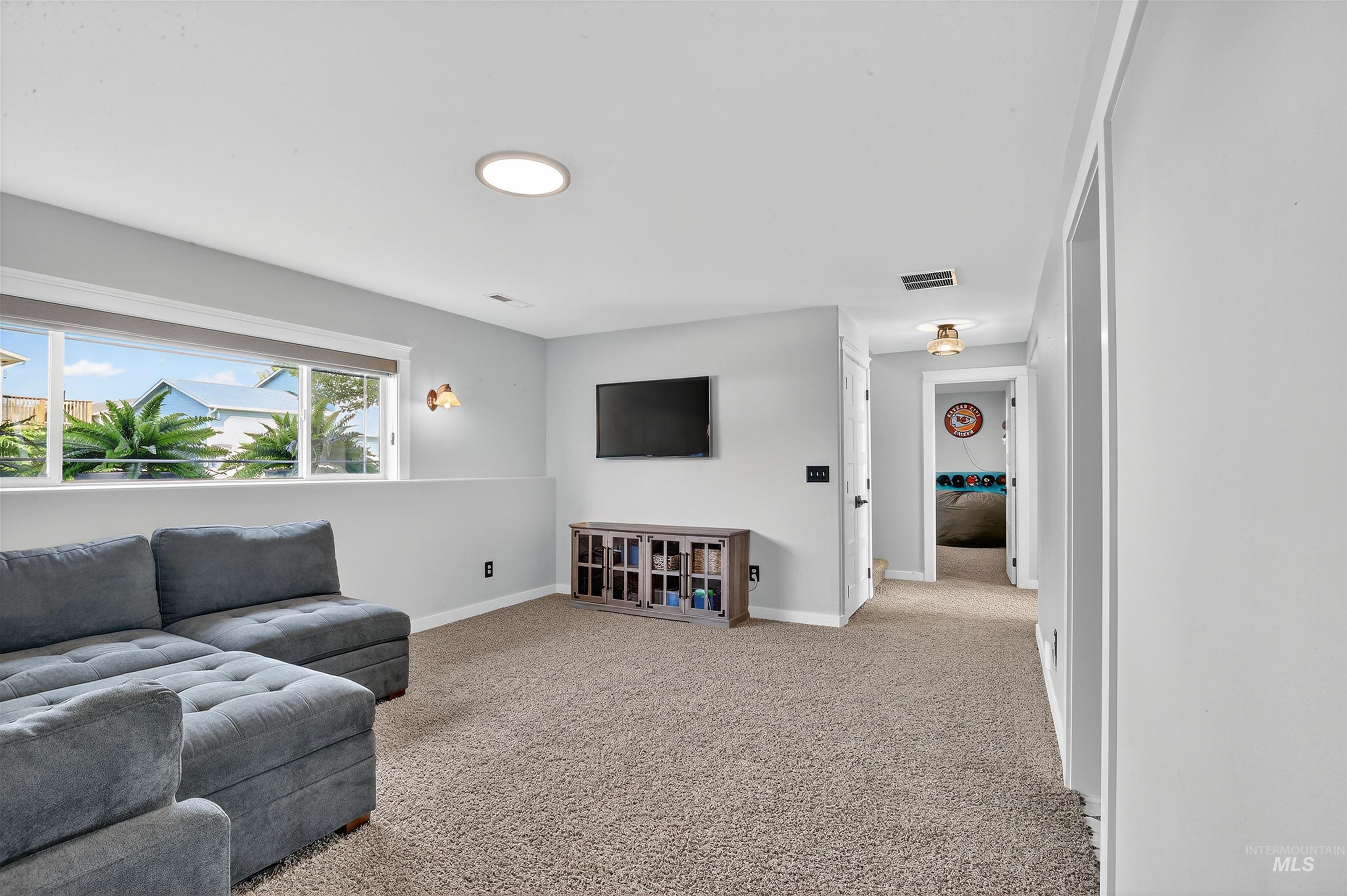 Living room with light carpet and baseboards