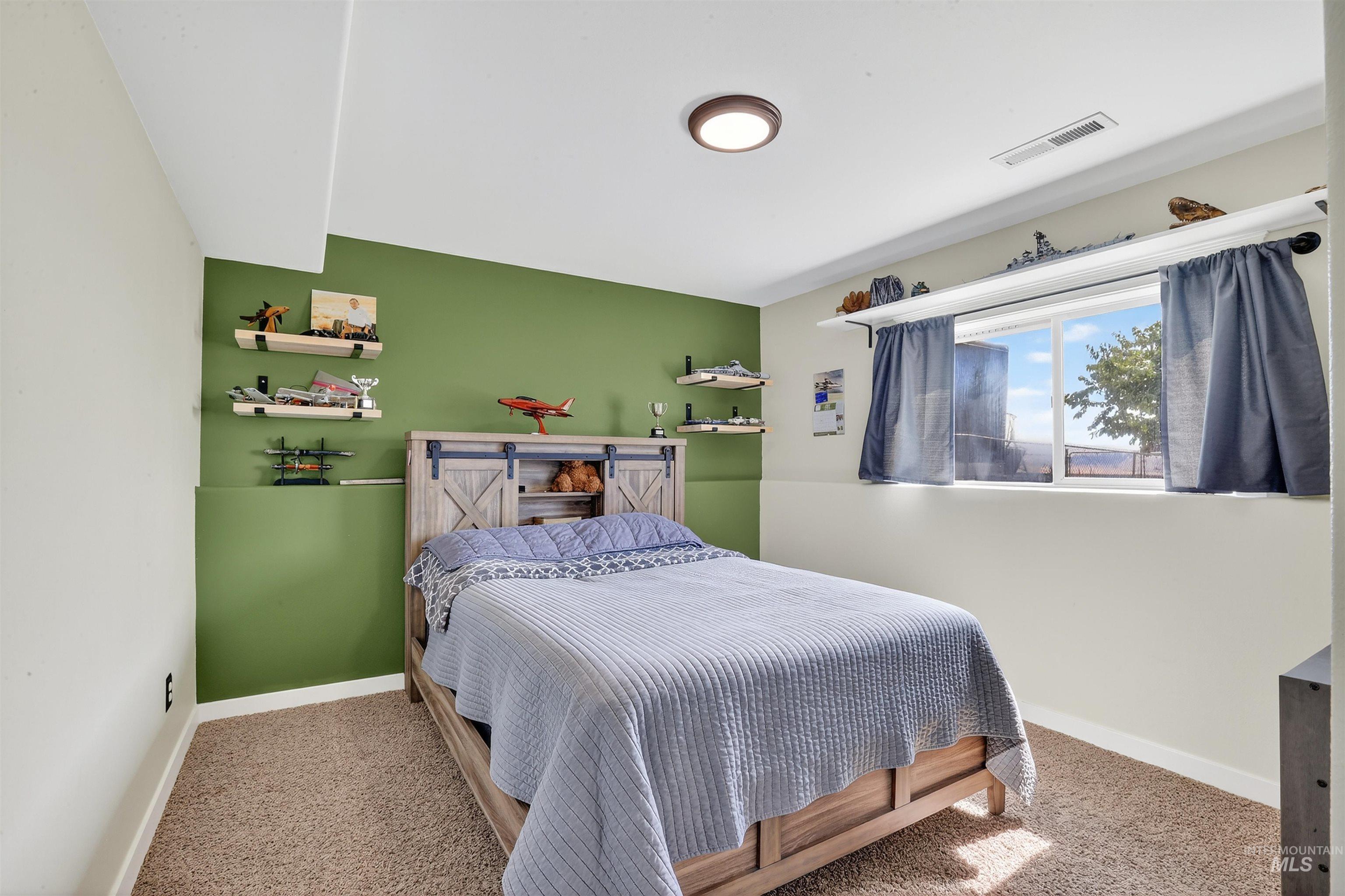 Bedroom featuring carpet floors and baseboards