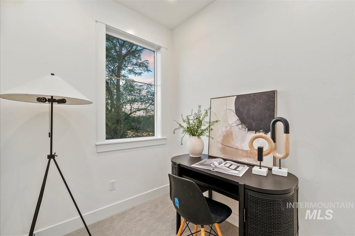 Office area with baseboards and carpet flooring
