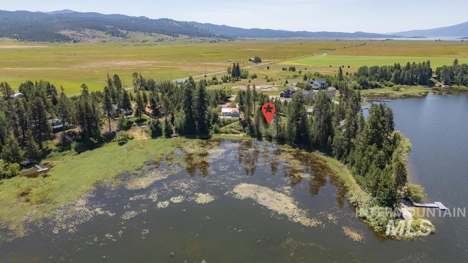 Aerial view of property's location with a water and mountain view and rural landscape
