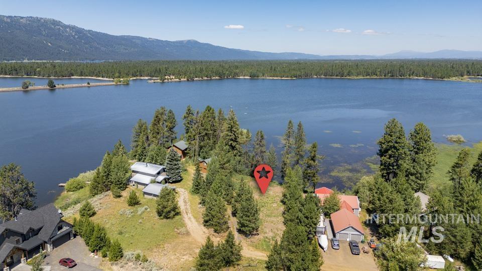 Aerial view of a water and mountain view and a heavily wooded area