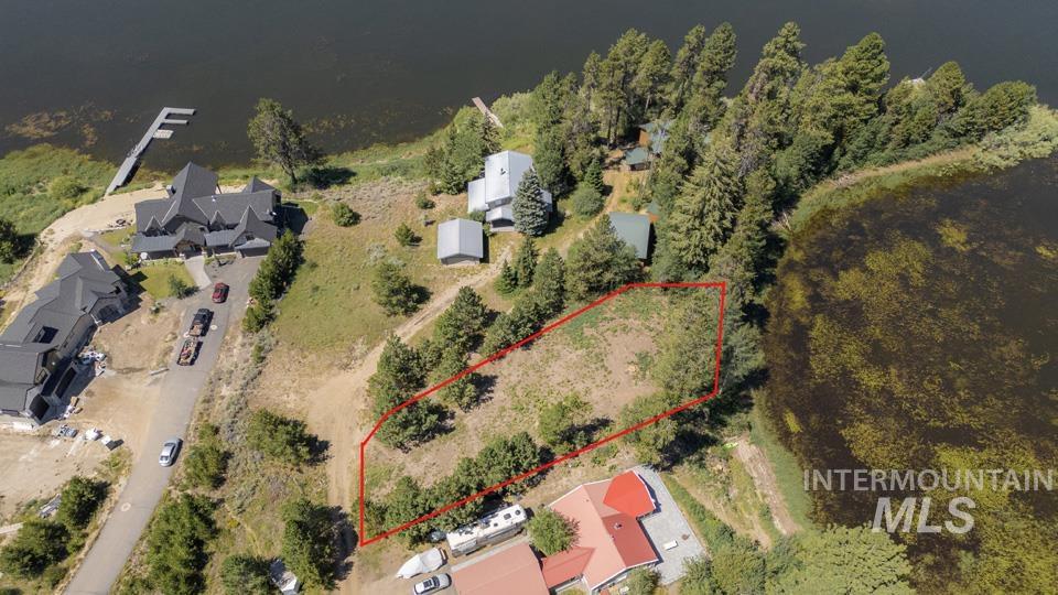 Aerial view of property and surrounding area featuring property boundaries highlighted