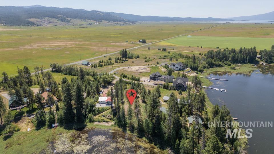 Aerial overview of property's location with rural landscape and a water and mountain view