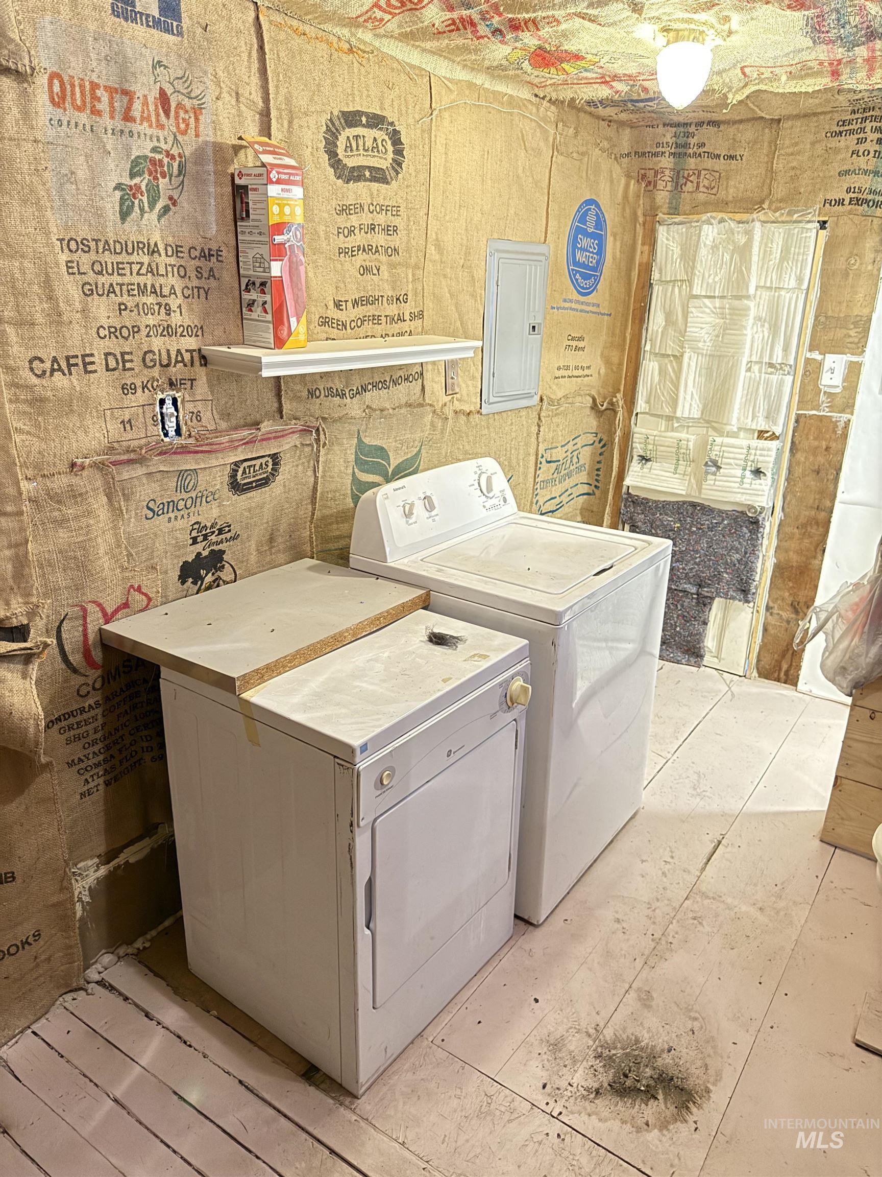 Laundry area featuring washing machine and dryer and electric panel