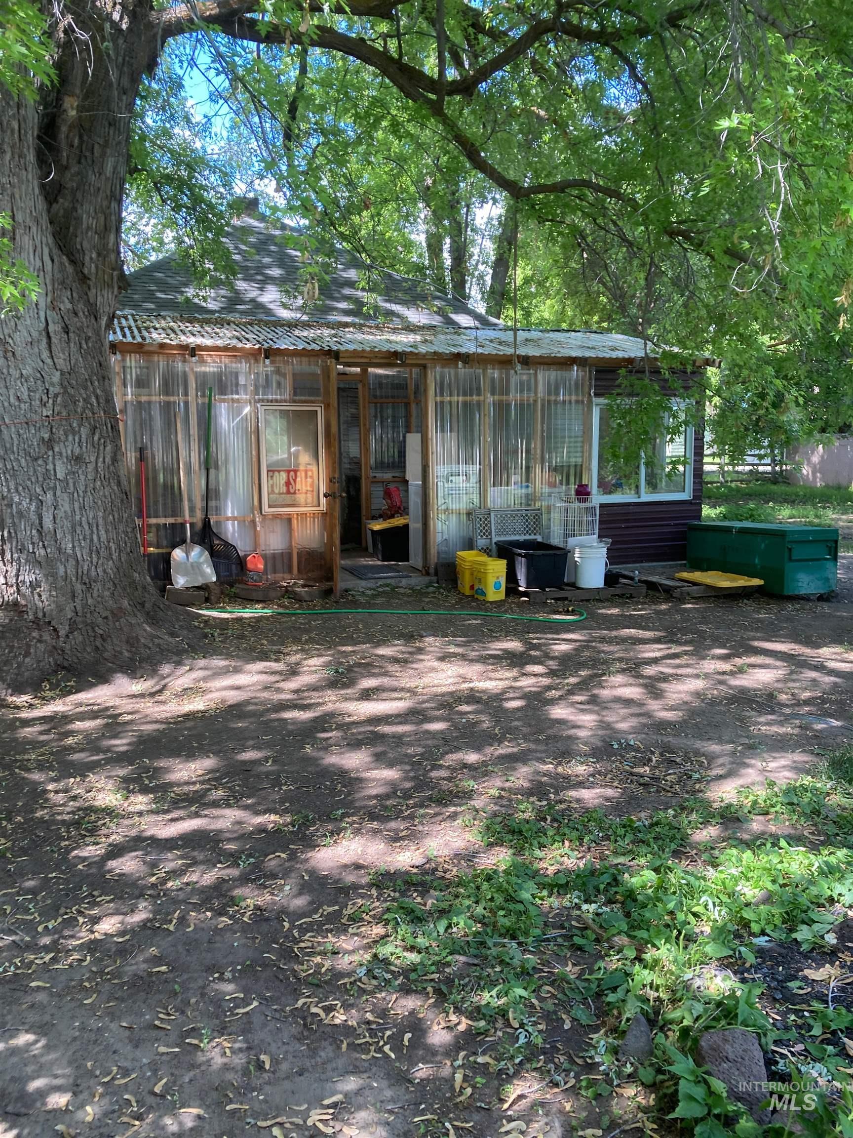 Back of property with a sunroom