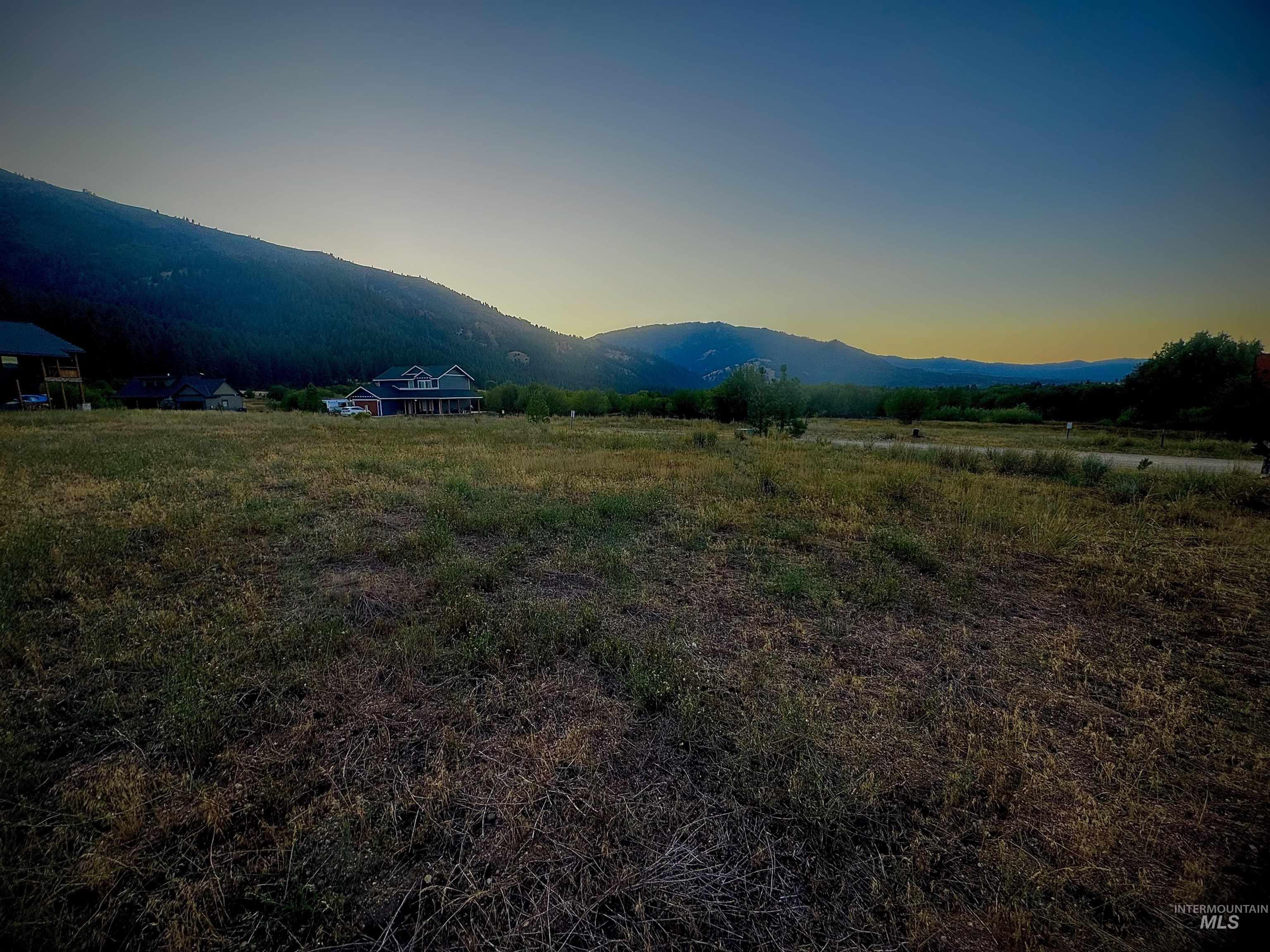 View of mountain backdrop featuring rural landscape