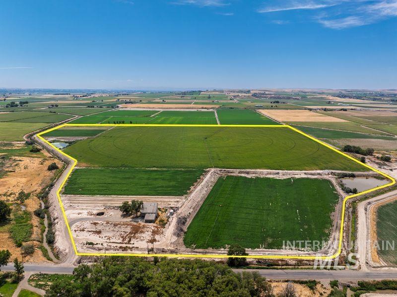 Aerial view of sparsely populated area with property boundaries highlighted and extensive farmland