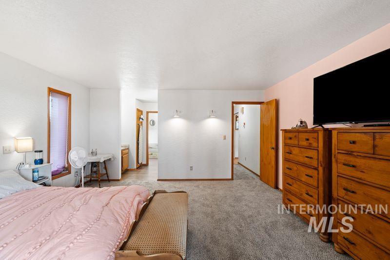 Bedroom with carpet flooring and baseboards
