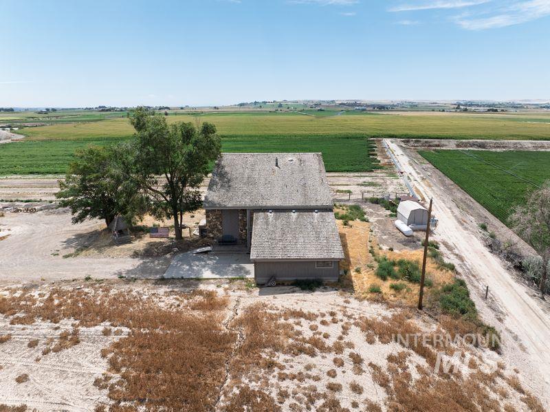 Aerial view of sparsely populated area featuring rows of crops