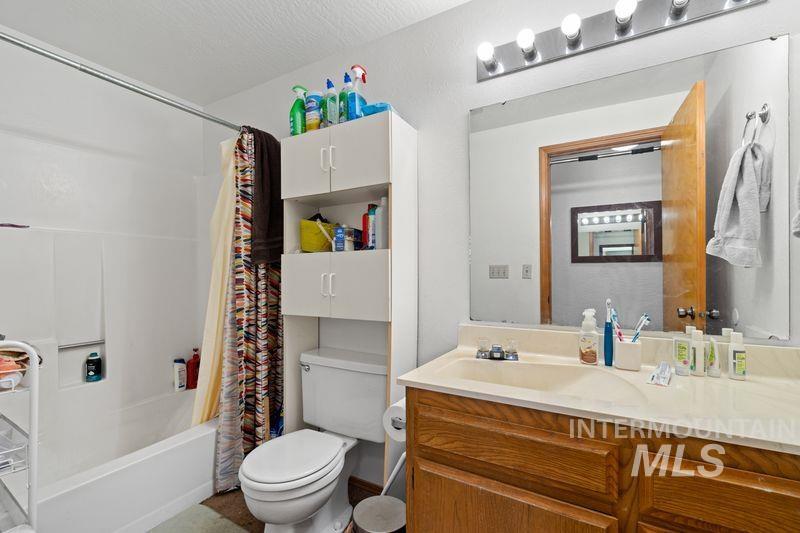 Bathroom featuring vanity and shower / tub combo with curtain