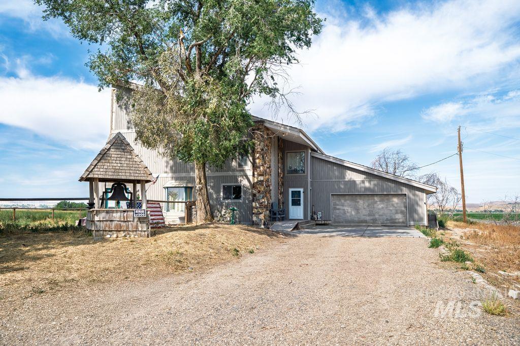 View of front of property with driveway and a garage