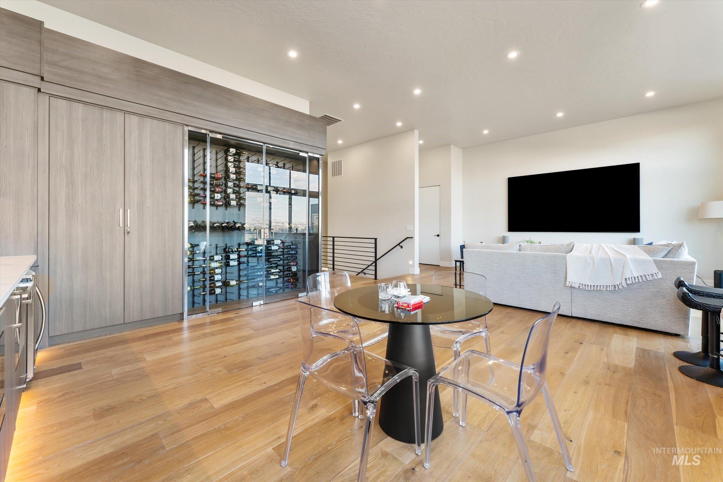 Integrated wine refrigeration unit with glass doors, flanked by wood-finish cabinetry