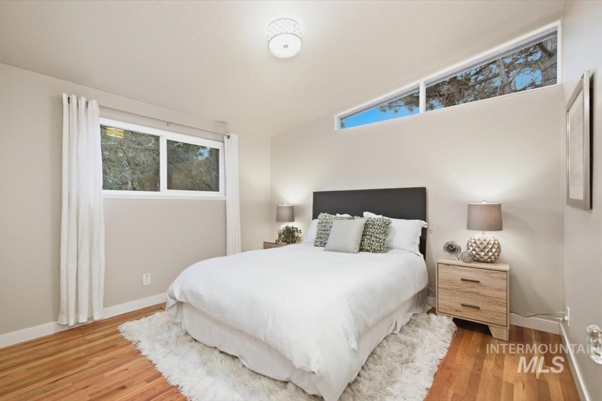 Bedroom with baseboards and light wood-style flooring