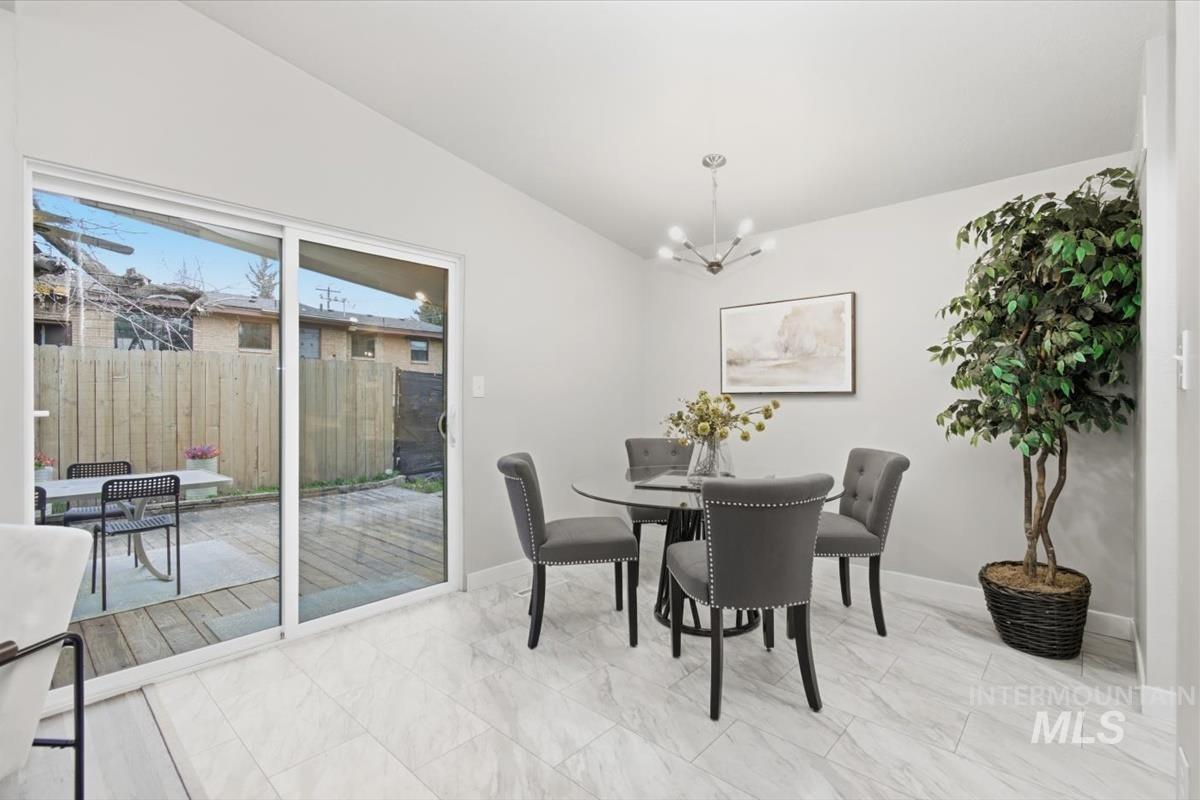 Dining area featuring lofted ceiling and hanging lights