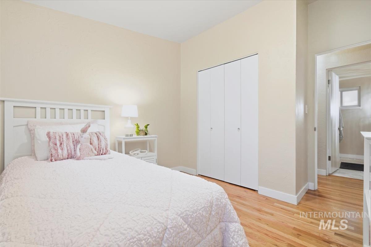 Bedroom featuring a closet and light wood finished floors