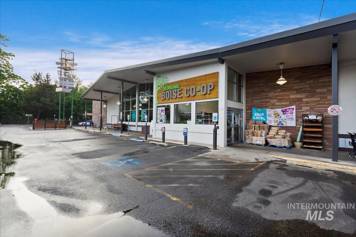 View of commercial property featuring uncovered parking