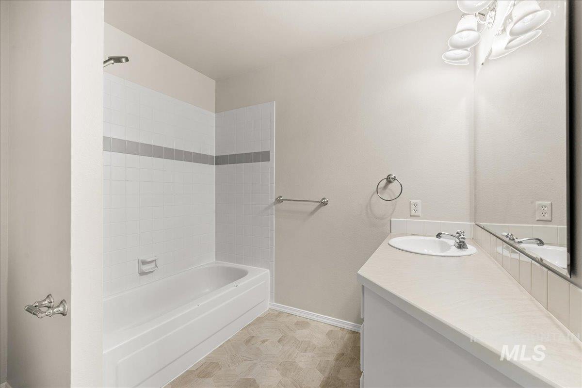 Full bathroom featuring vanity and shower / bath combination