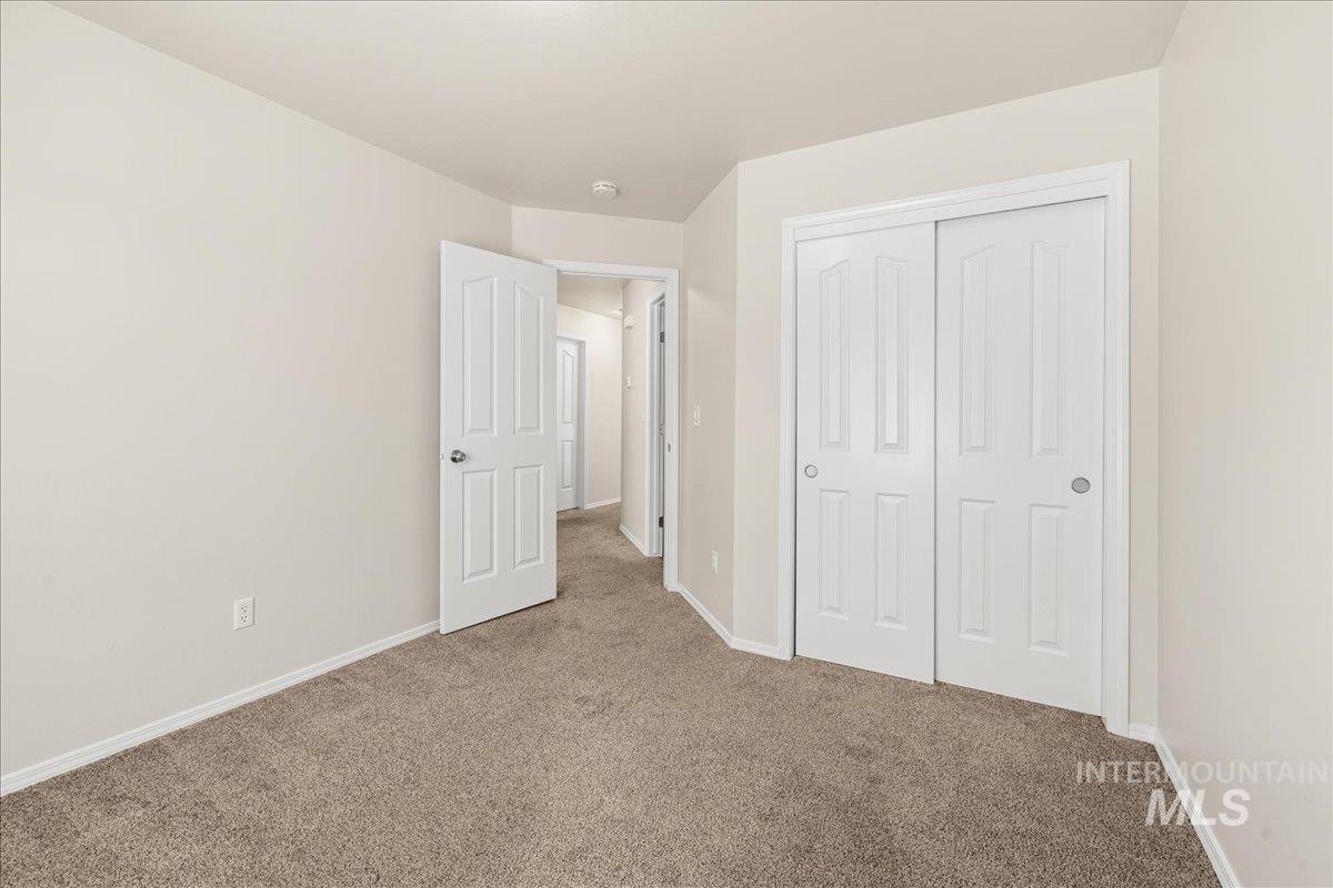 Unfurnished bedroom featuring carpet floors and a closet