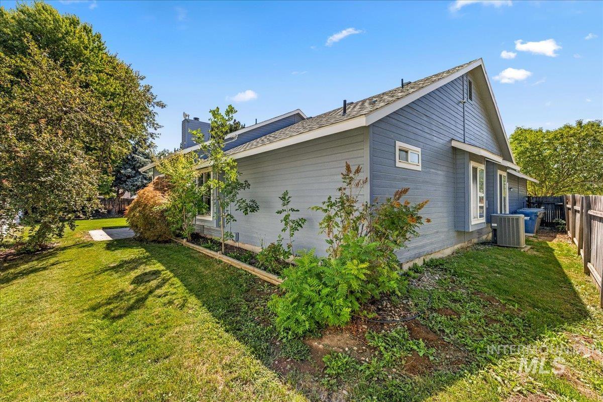 View of property exterior featuring a chimney and a central air condition unit