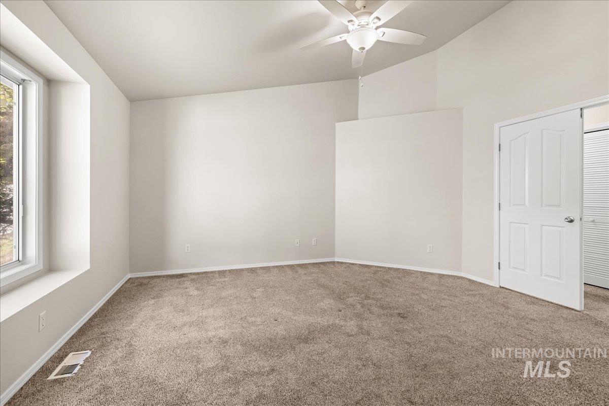 Unfurnished bedroom featuring carpet floors, ceiling fan, and a closet