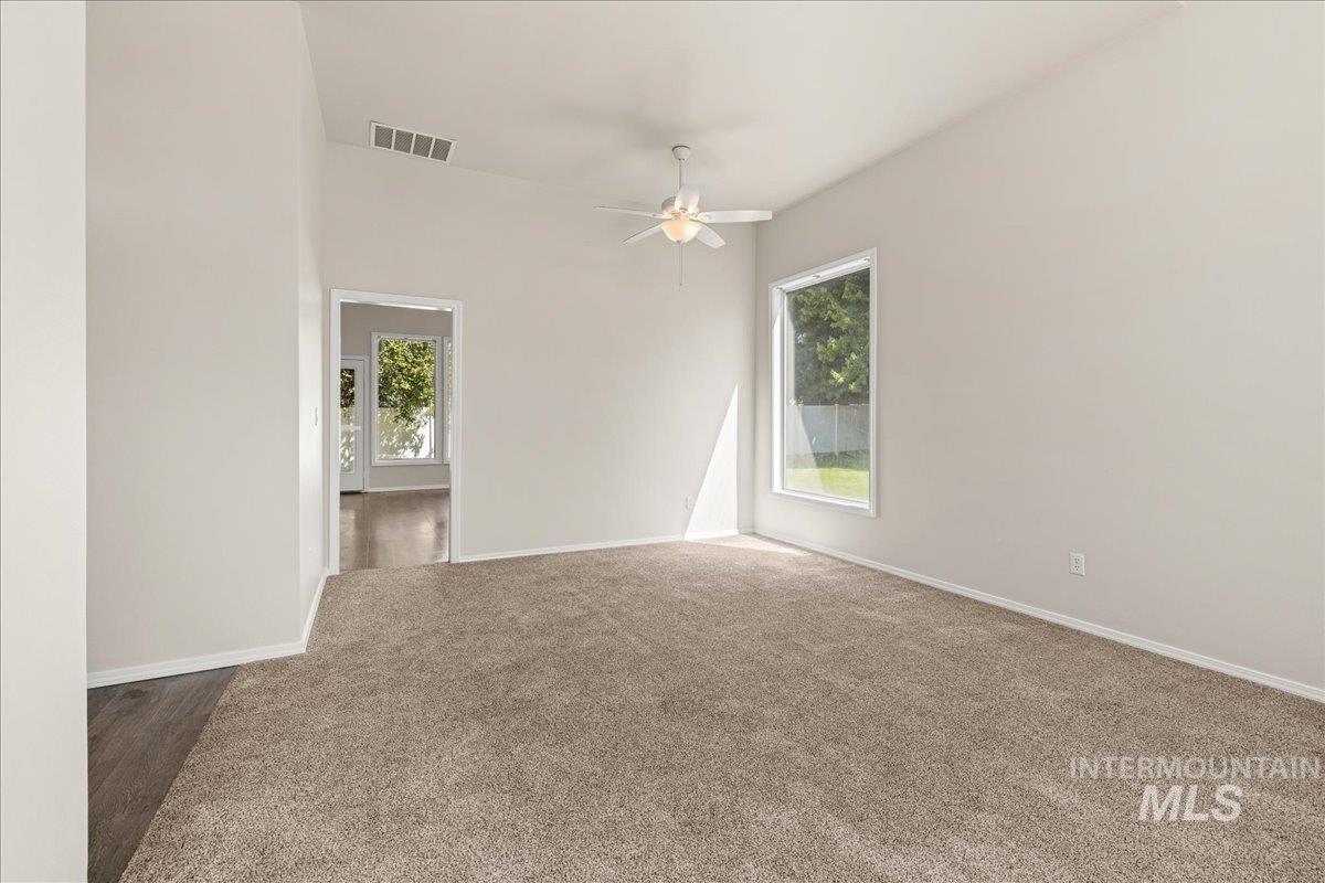 Spare room with carpet flooring and ceiling fan