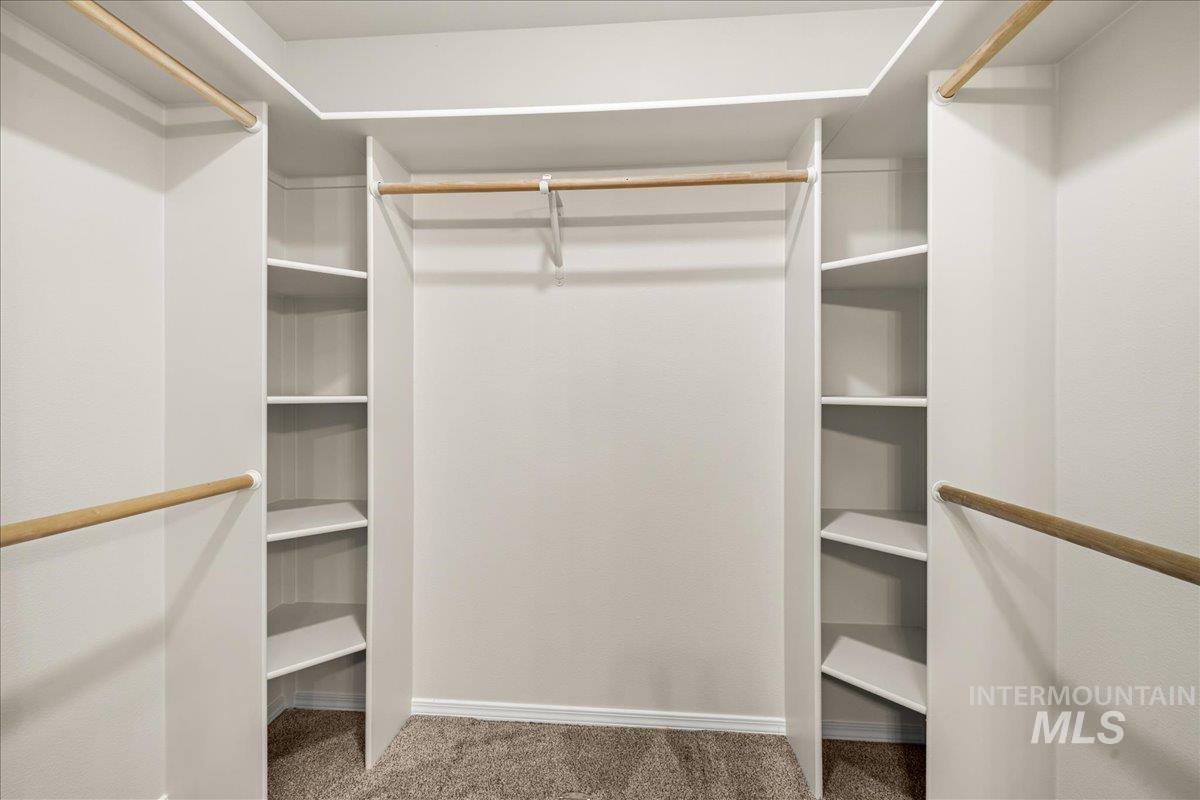 Spacious closet with light colored carpet