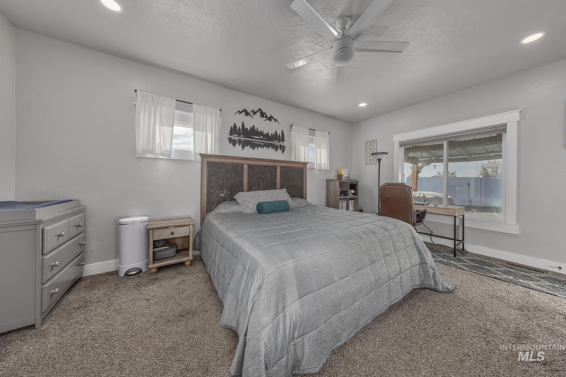 Bedroom featuring carpet flooring, a ceiling fan, and recessed lighting