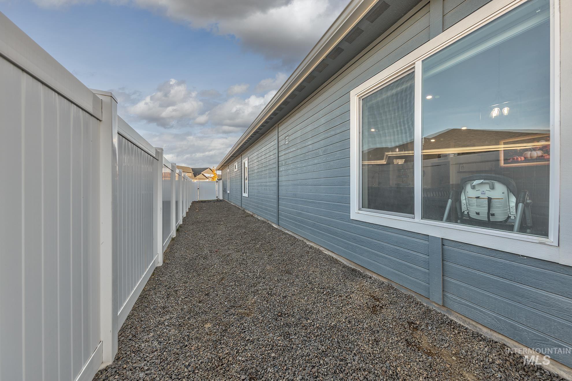View of property exterior featuring a fenced backyard