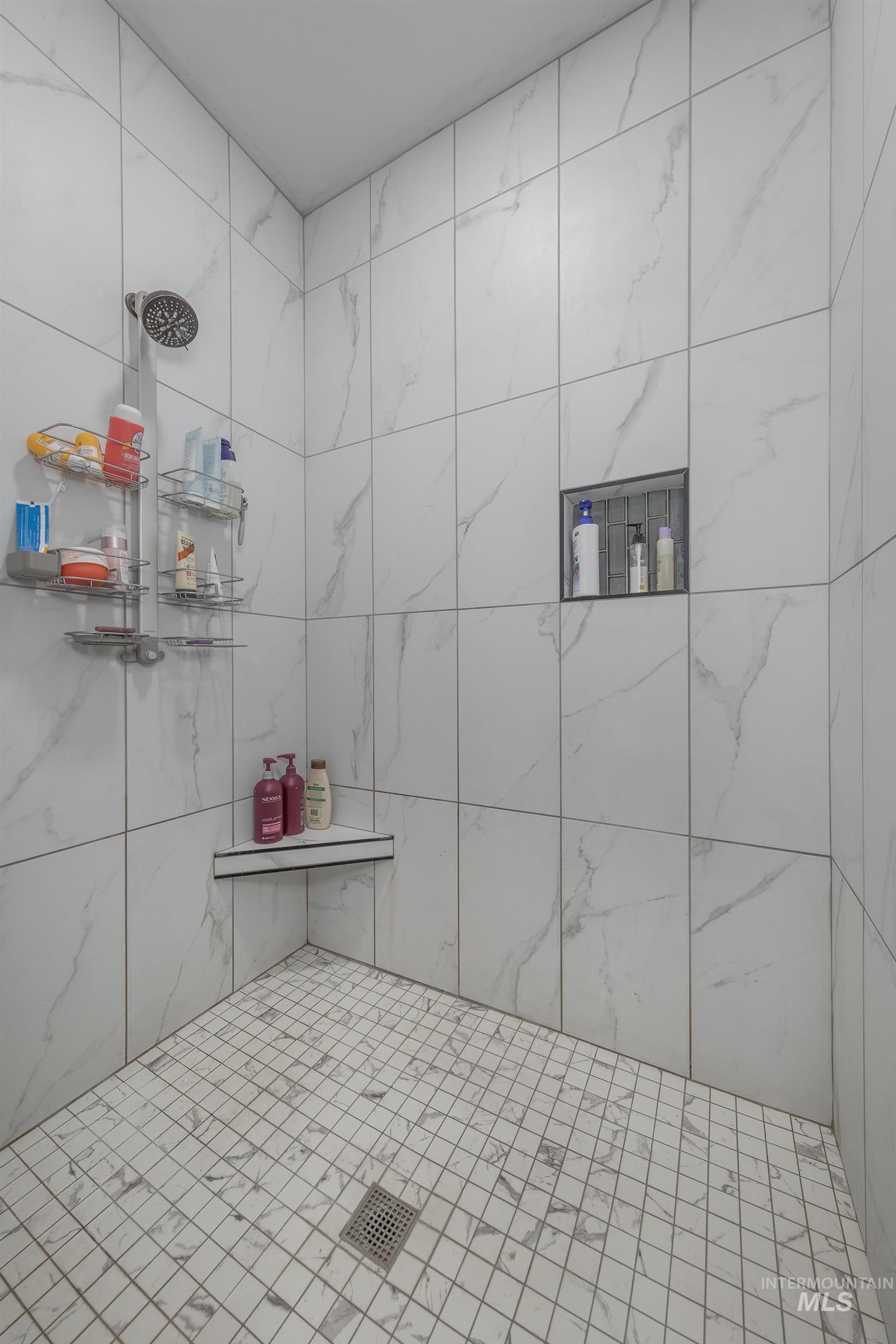 Bathroom featuring a tile shower