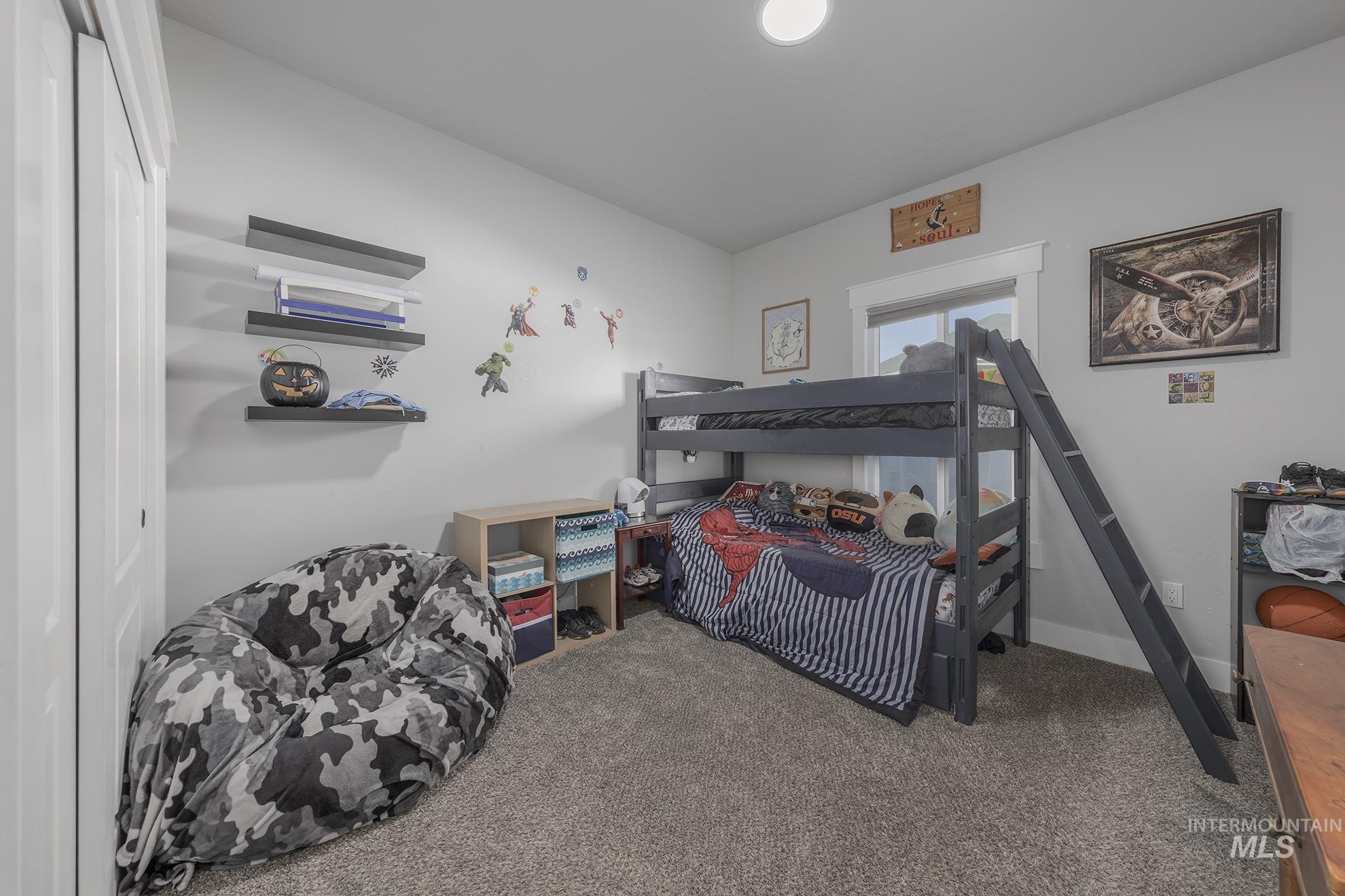 Bedroom featuring carpet flooring and baseboards