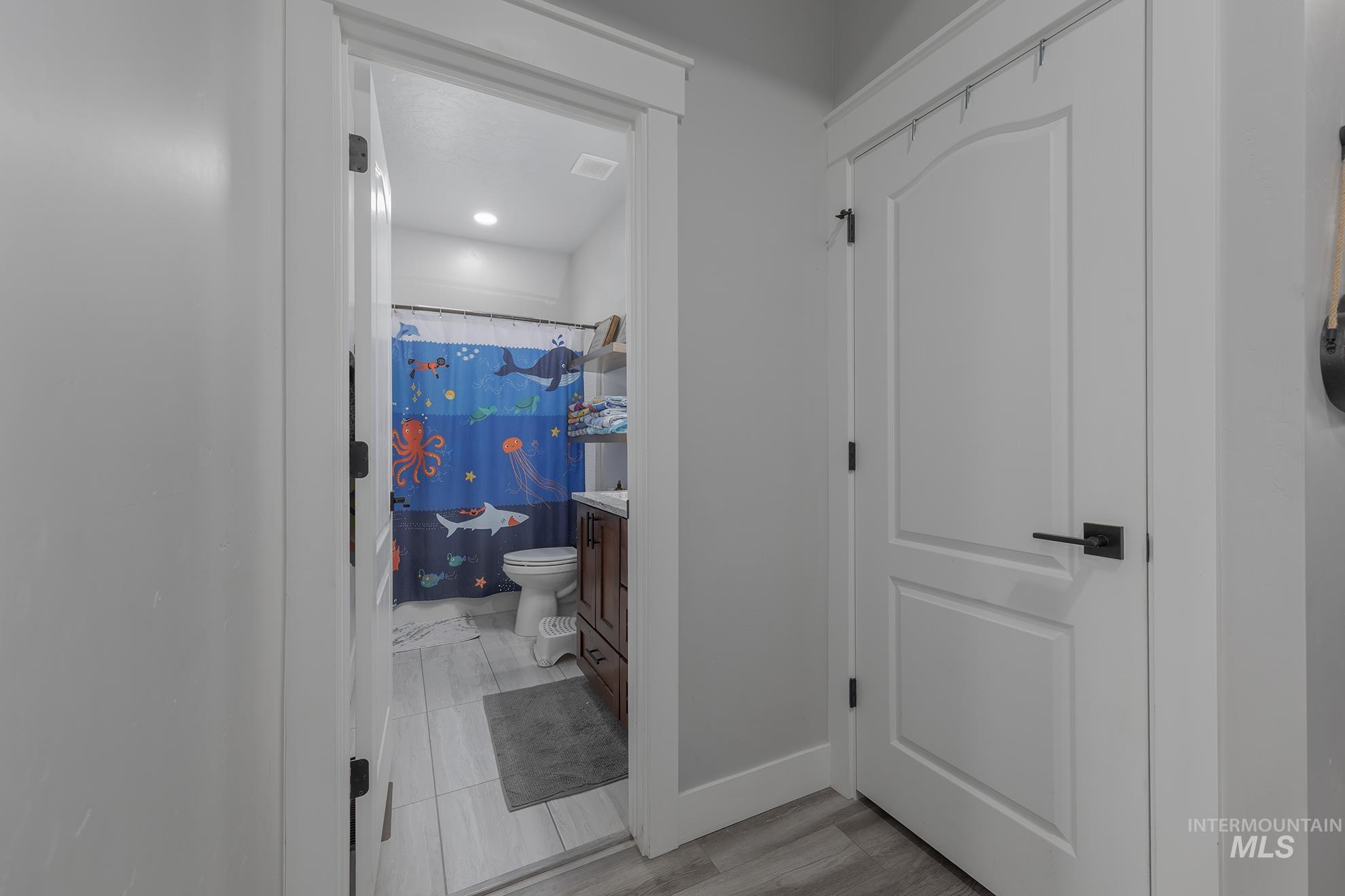 Corridor with baseboards and light wood-style floors