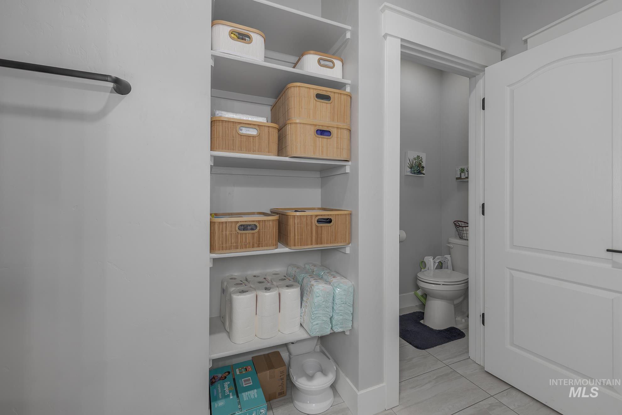 Bathroom featuring toilet and light tile patterned floors