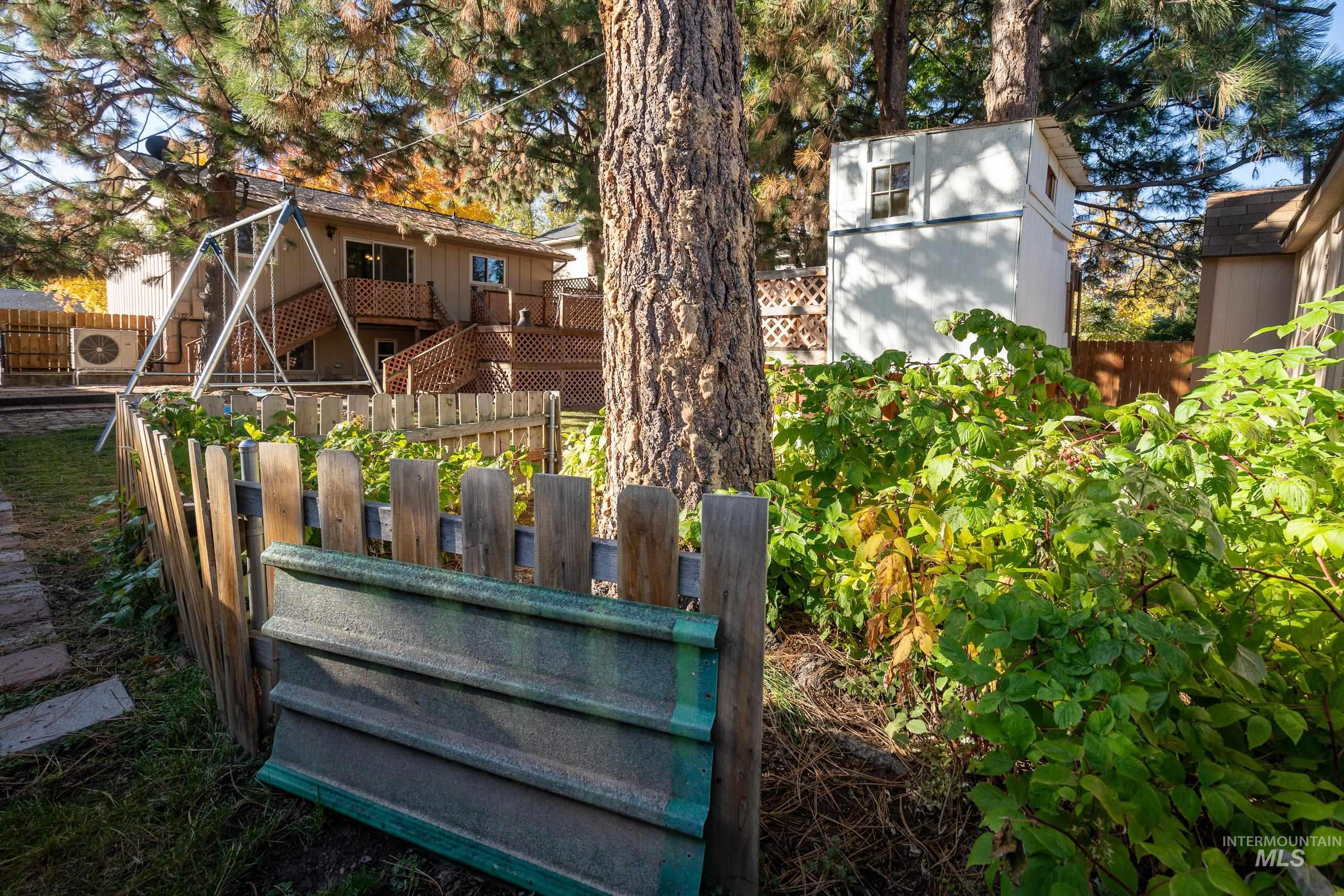 Rear view of house with stairs and a wooden deck