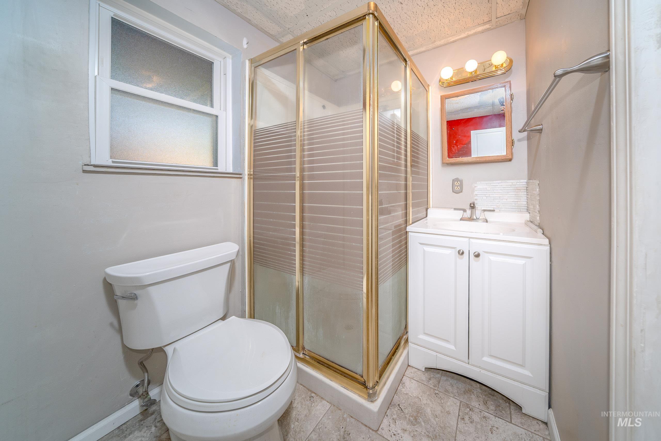 Full bath with vanity and a shower stall