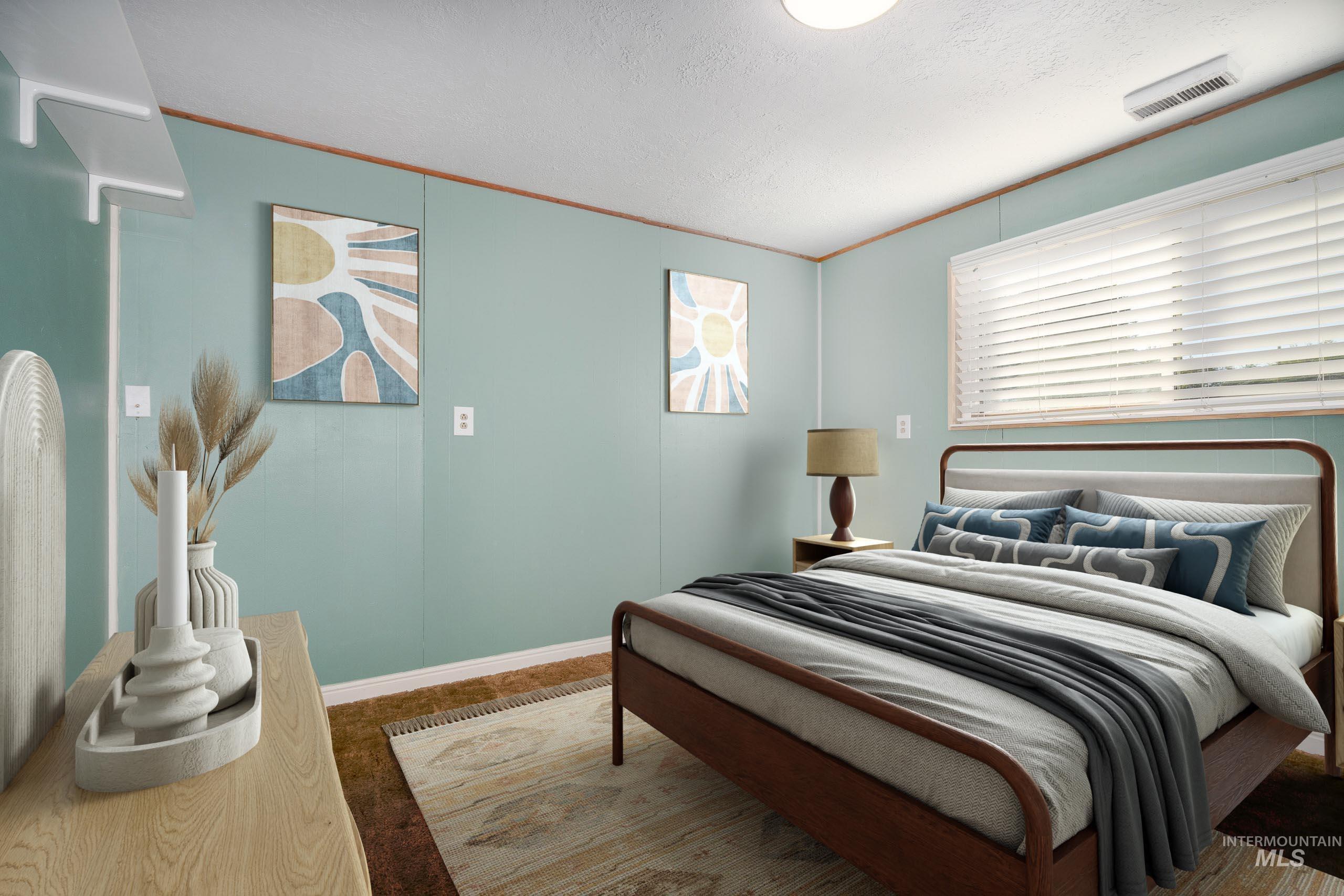 Bedroom featuring a textured ceiling and carpet