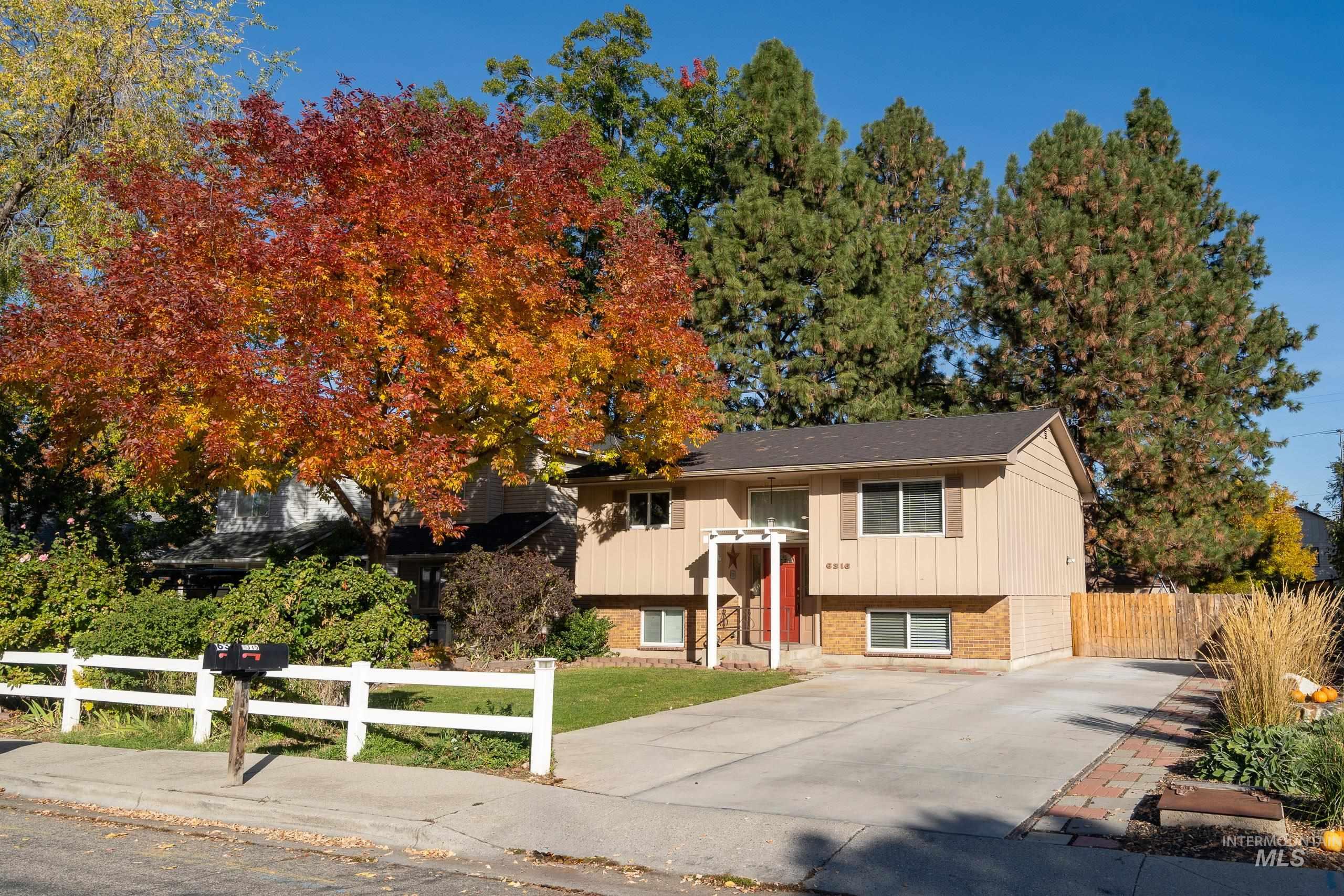 Bi-level home featuring brick siding and driveway
