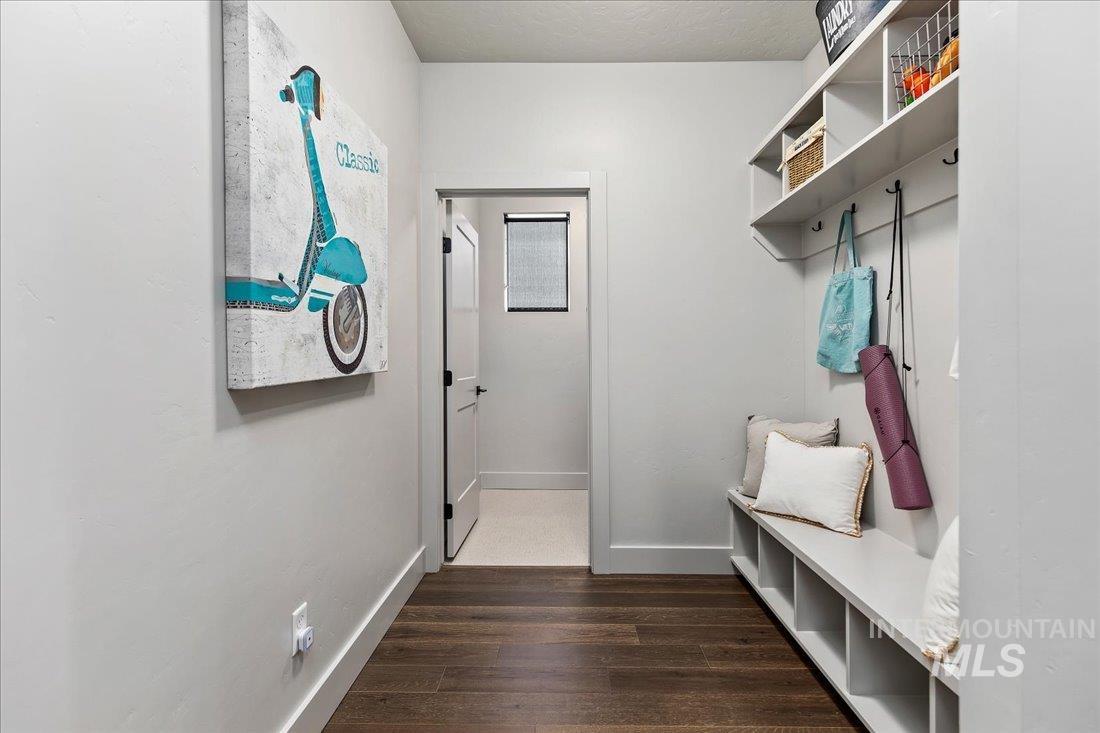 Mudroom featuring baseboards and dark wood-style flooring