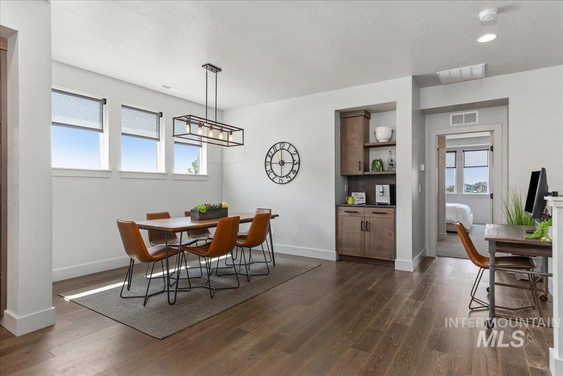Dining space with dark wood finished floors