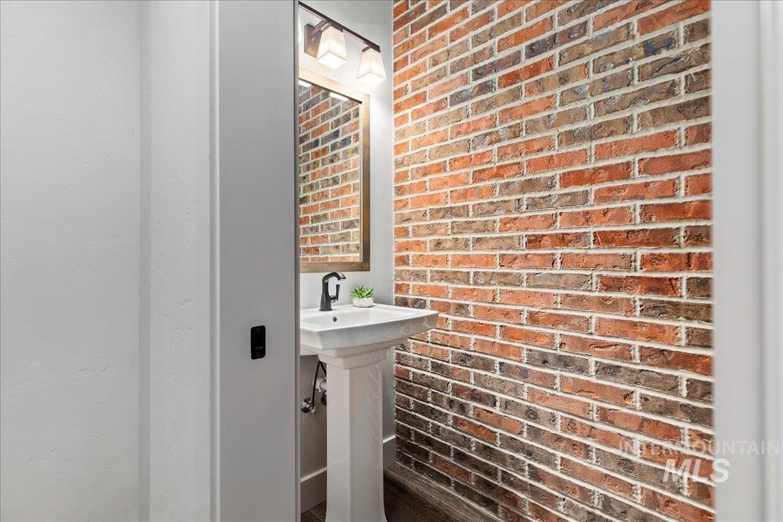 Bathroom featuring brick wall