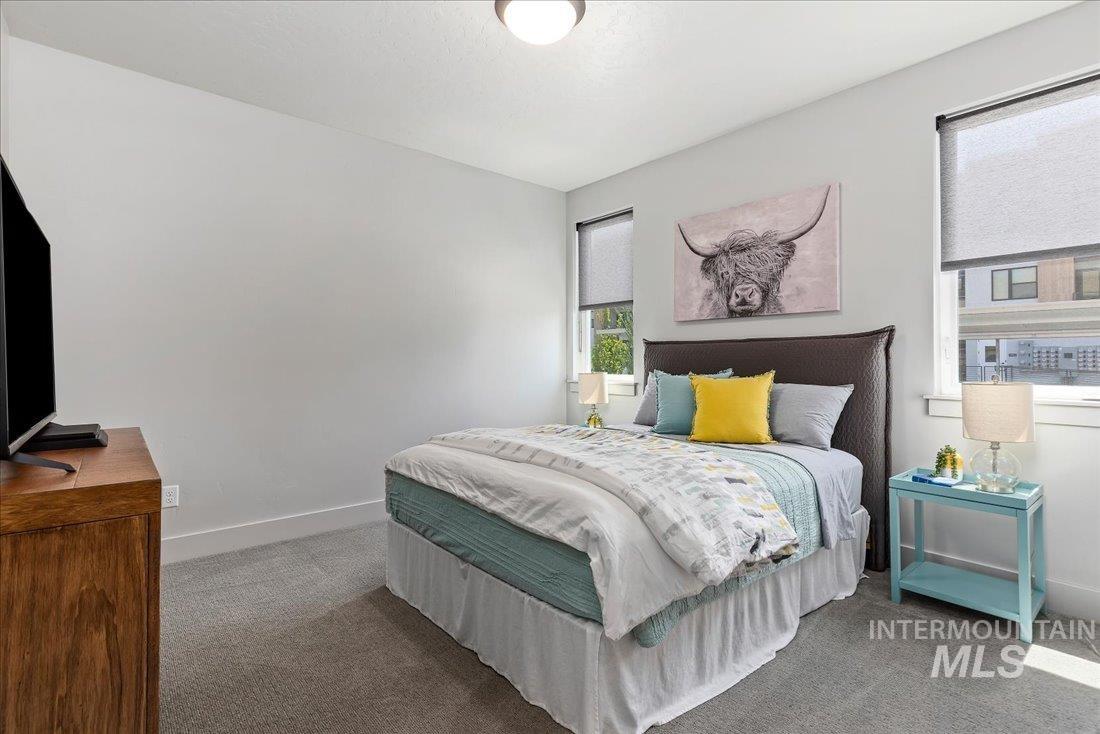 Carpeted bedroom featuring baseboards