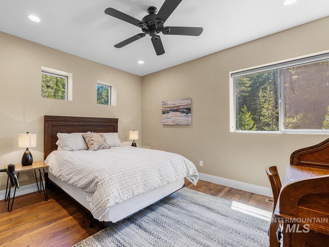 Bedroom with wood finished floors, recessed lighting, and a ceiling fan