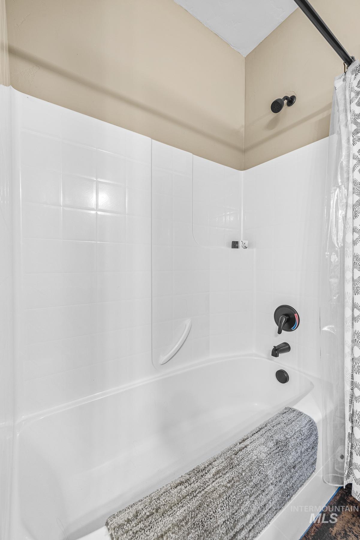 Full bathroom featuring shower / bath combination with curtain