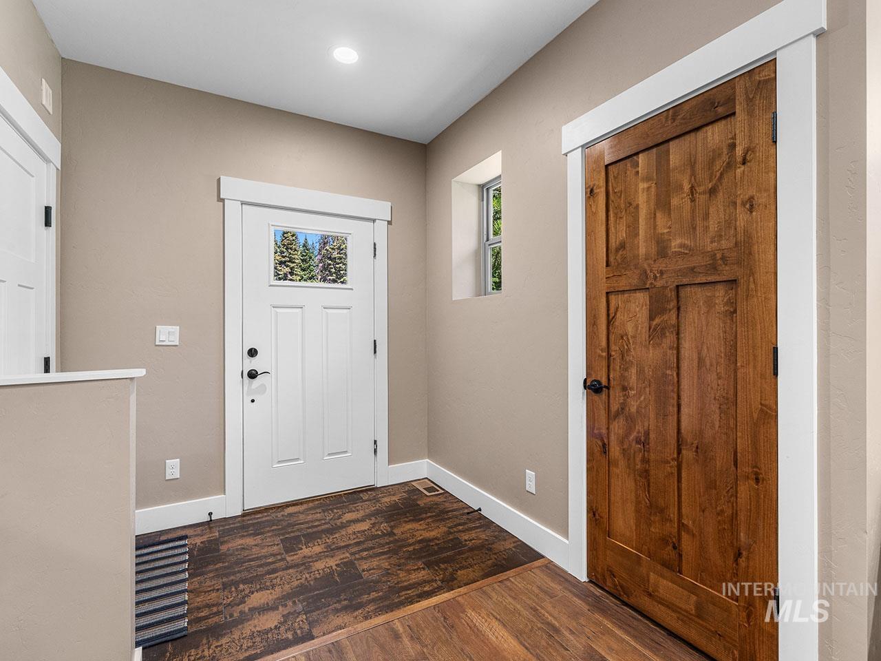 Entrance foyer featuring dark wood finished floors and recessed lighting