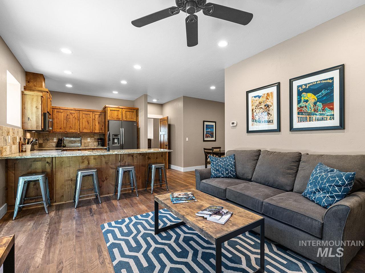 Living area with wood finished floors, recessed lighting, and a ceiling fan