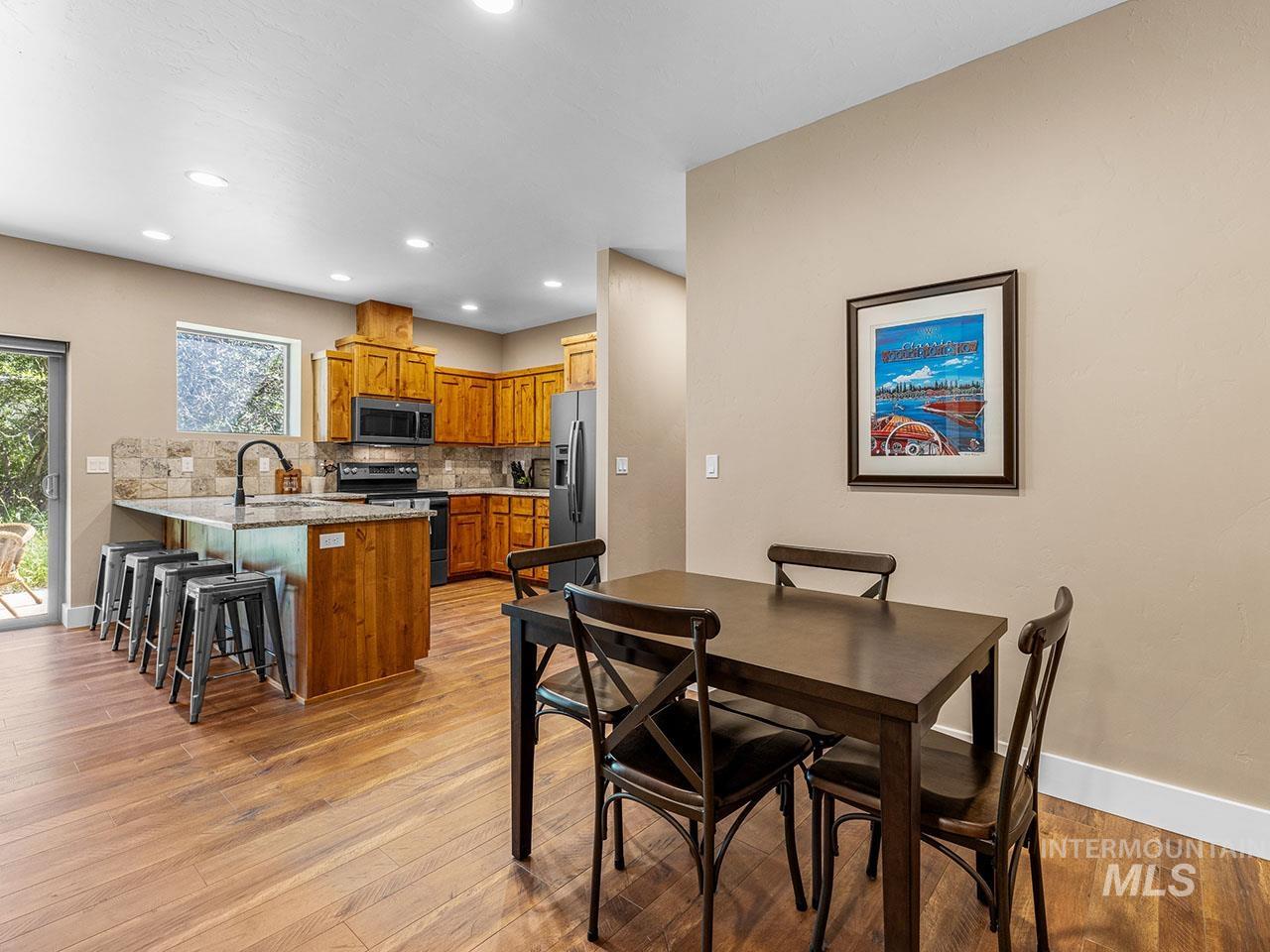 Dining area featuring recessed lighting and light wood-type flooring