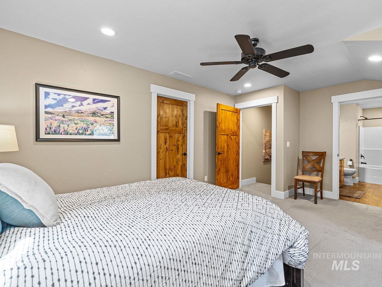 Bedroom with carpet, recessed lighting, ceiling fan, and connected bathroom