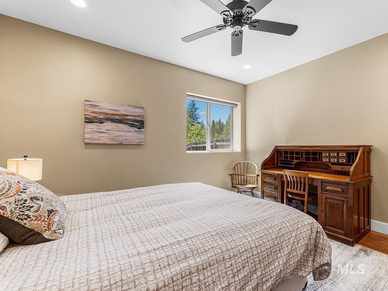 Bedroom featuring wood finished floors, recessed lighting, and a ceiling fan