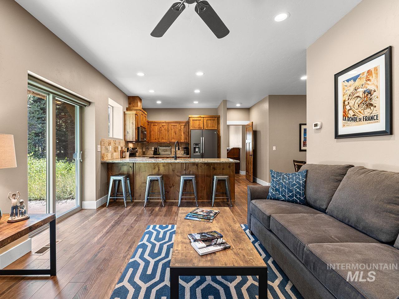 Living room with ceiling fan, wood-type flooring, and recessed lighting