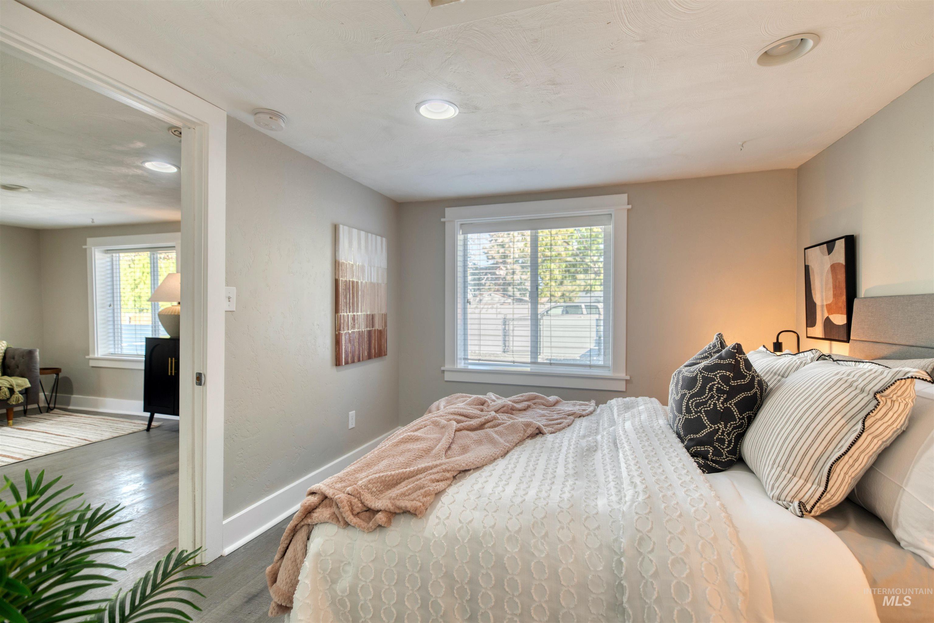 Bedroom featuring multiple windows, wood finished floors, and recessed lighting