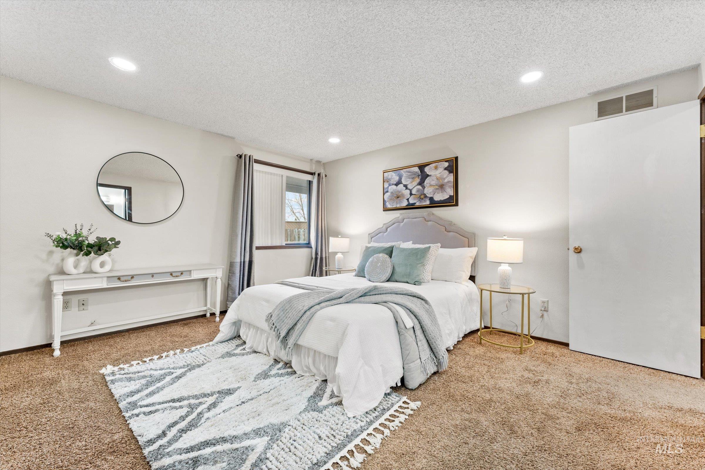 Bedroom with carpet flooring, a textured ceiling, and recessed lighting